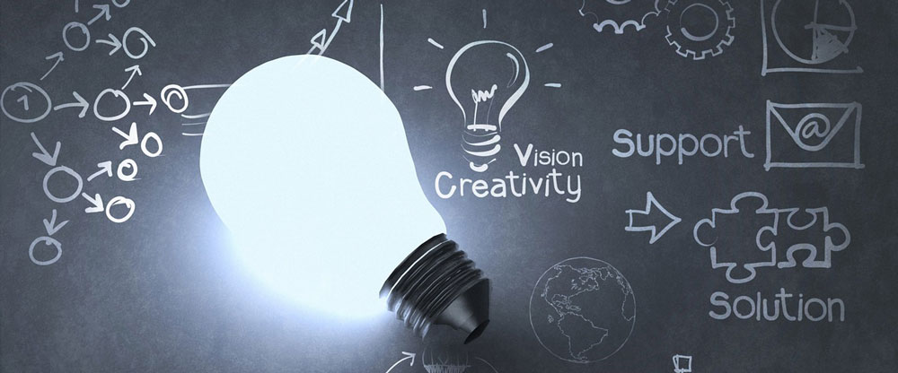 Stock photo of a light bulb with a background that says vision and creativity.