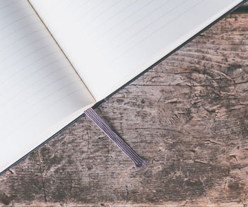 Journal open and laying on a wooden table